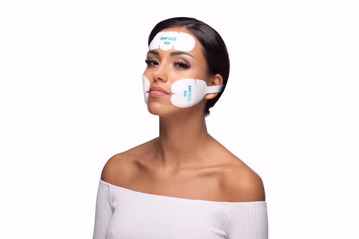 Woman with Emface applicators on her forehead and cheeks