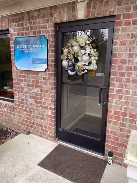 Wave It Away entrance with the sign by the door