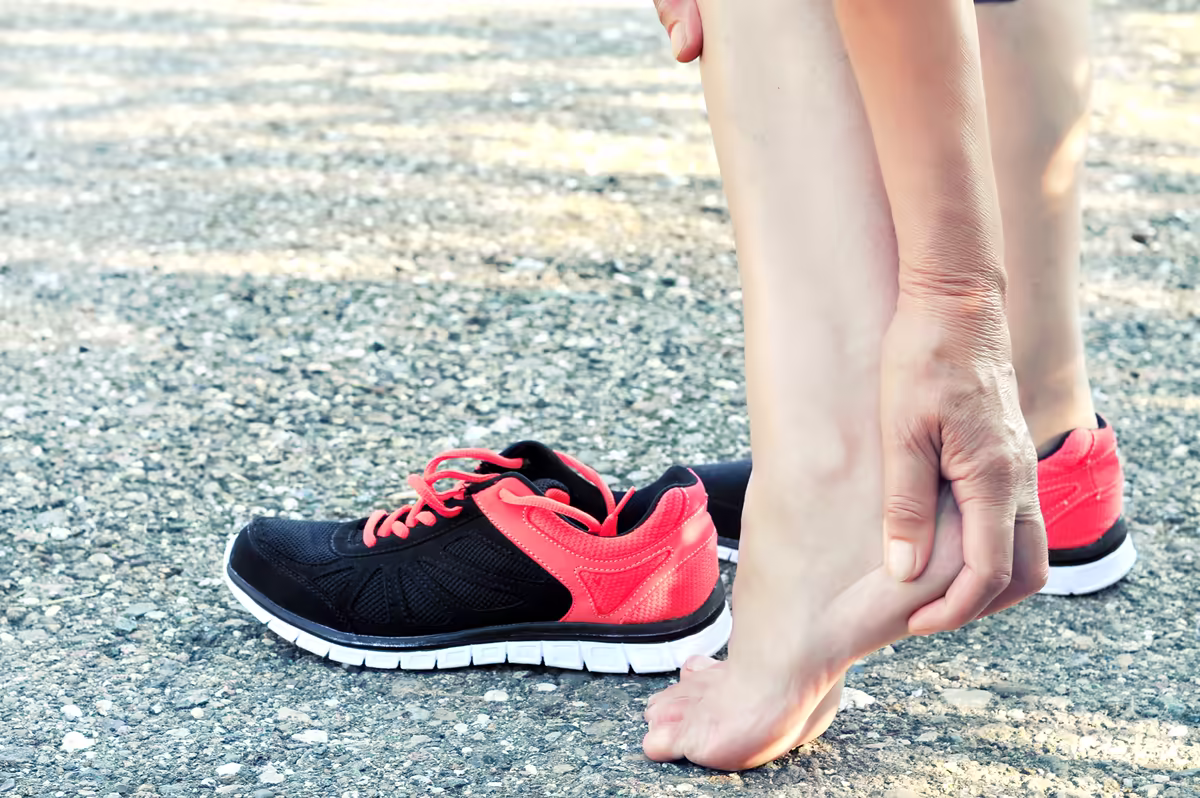 Woman holding her heel after a run