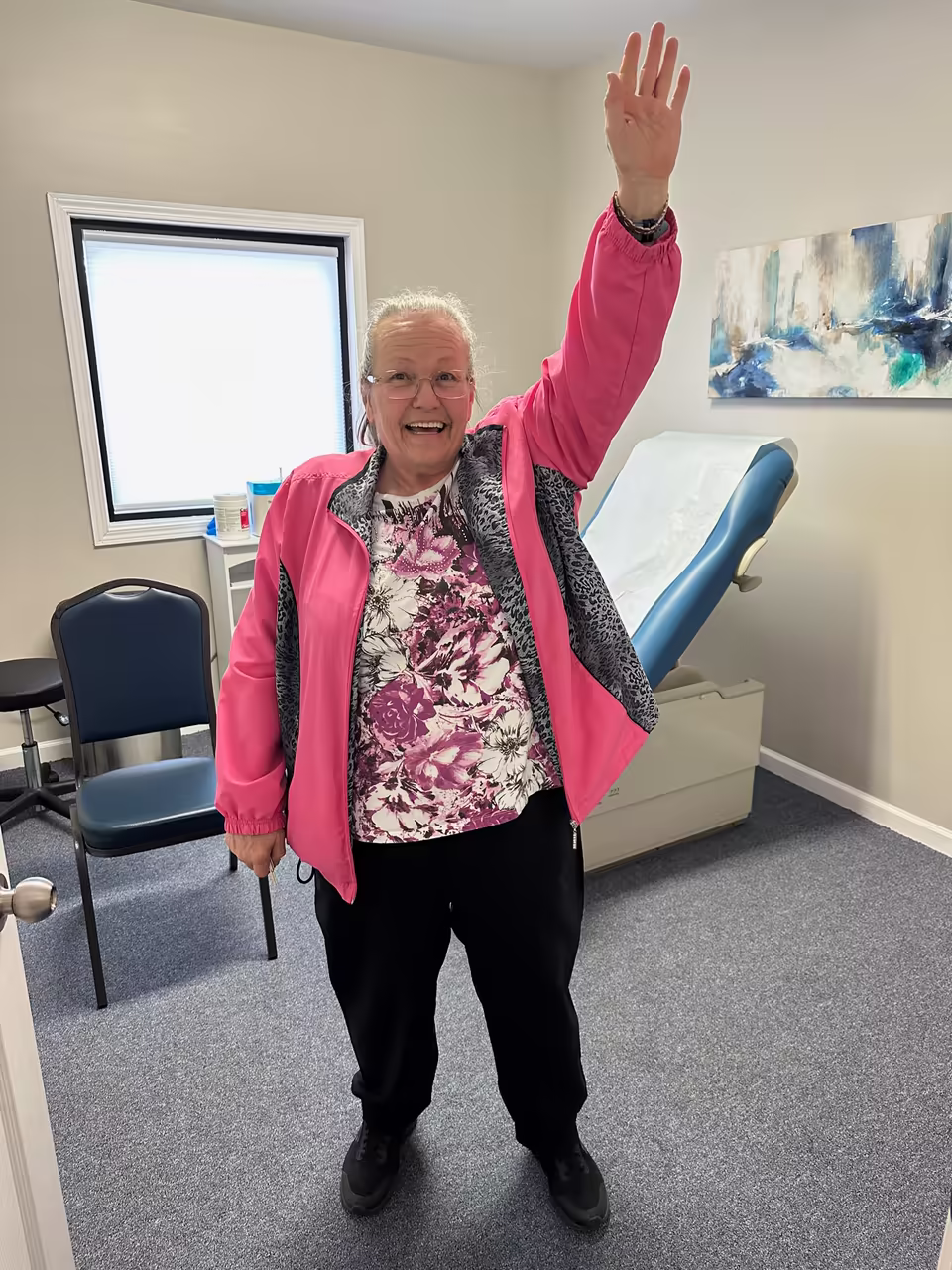 The same patient raising her arm overhead after one treatment