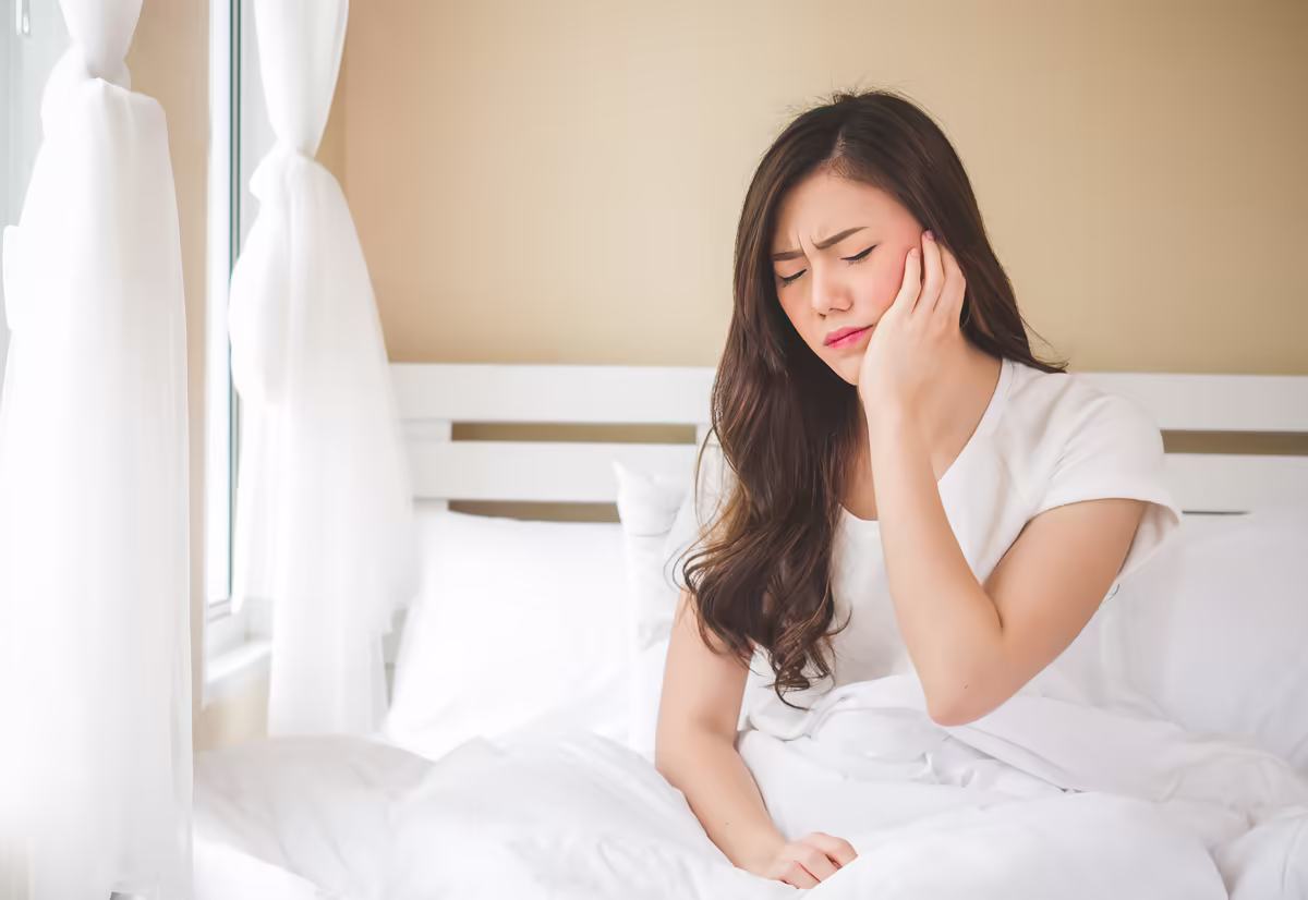 Woman holding her jaw in pain